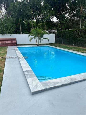 280 NE 169th St, North Miami Beach, FL 33162 - view of pool featuring a fenced backyard