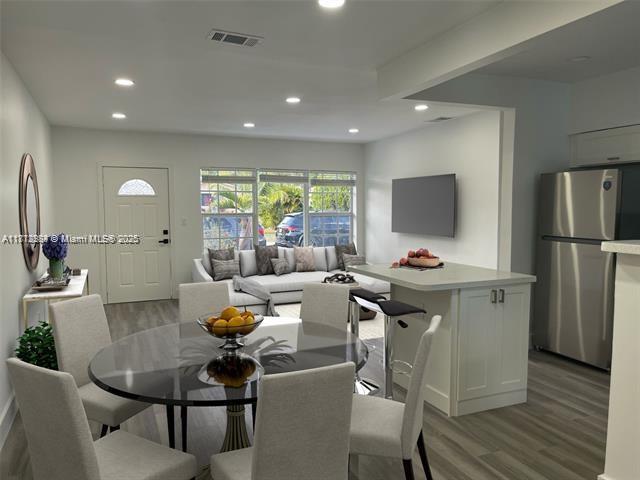 280 NE 169th St, North Miami Beach, FL 33162 - dining area with light wood-style floors and recessed lighting