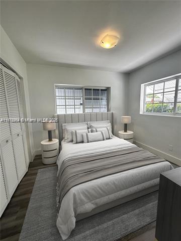280 NE 169th St, North Miami Beach, FL 33162 - bedroom with a closet and dark wood-style floors