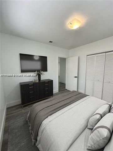 280 NE 169th St, North Miami Beach, FL 33162 - bedroom featuring baseboards and a closet