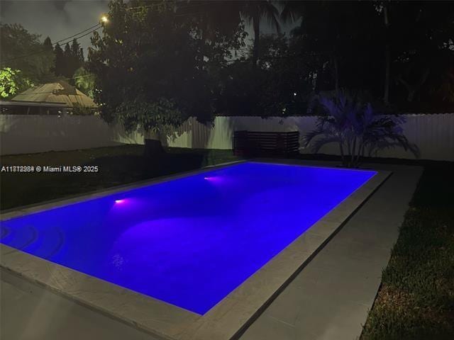 280 NE 169th St, North Miami Beach, FL 33162 - pool at night with a fenced backyard