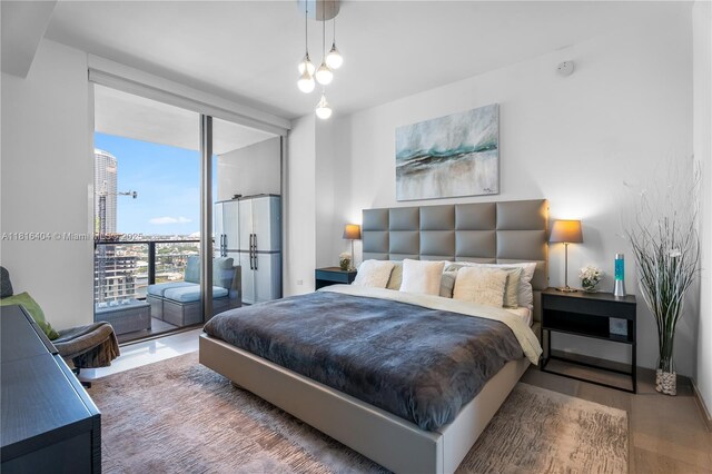 68 SE 6th St Unit 1704, Miami, FL 33131 - bedroom featuring wood finished floors and a wall of windows