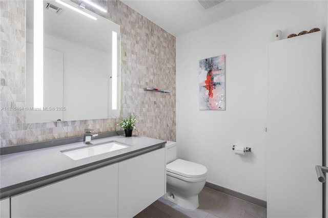 68 SE 6th St Unit 1704, Miami, FL 33131 - bathroom with vanity, toilet, tile walls, and baseboards