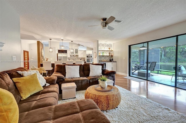 18366 Lake Bend Dr, Jupiter, FL 33458 - living area featuring light wood-type flooring, a ceiling fan, and a textured ceiling
