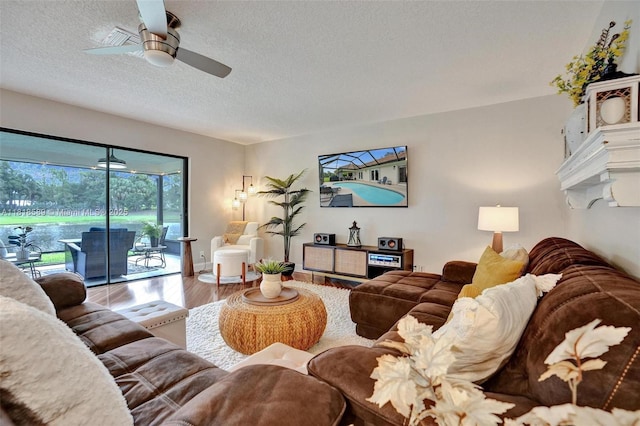 18366 Lake Bend Dr, Jupiter, FL 33458 - living area with wood finished floors, a textured ceiling, and a ceiling fan