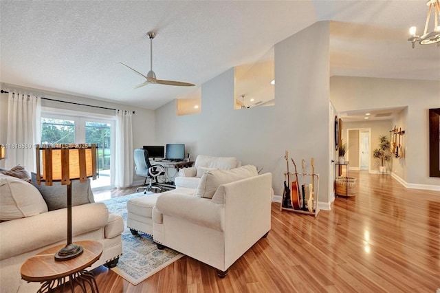 18366 Lake Bend Dr, Jupiter, FL 33458 - living area with lofted ceiling, light wood-type flooring, a desk, a ceiling fan, and a chandelier