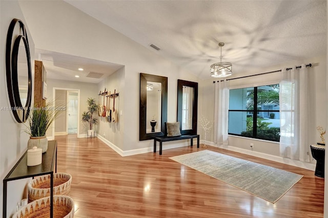 18366 Lake Bend Dr, Jupiter, FL 33458 - entrance foyer with light wood-style flooring, a chandelier, lofted ceiling, and a textured ceiling