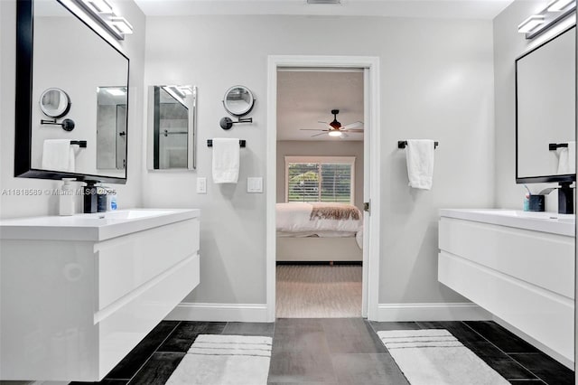 18366 Lake Bend Dr, Jupiter, FL 33458 - ensuite bathroom featuring a ceiling fan, two vanities, and wood finished floors