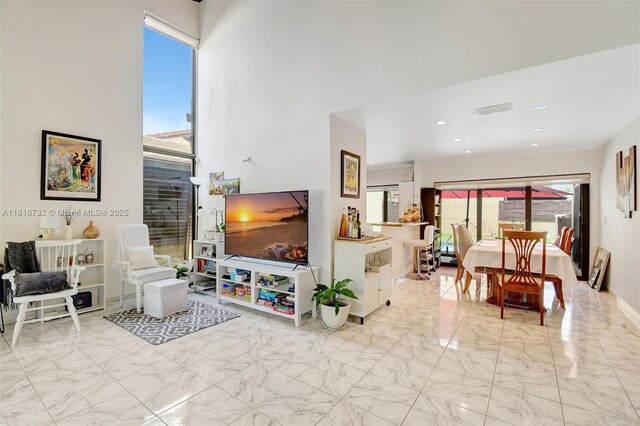 1057 NE 202nd Ln, Miami, FL 33179 - living area with marble finish flooring, plenty of natural light, and recessed lighting