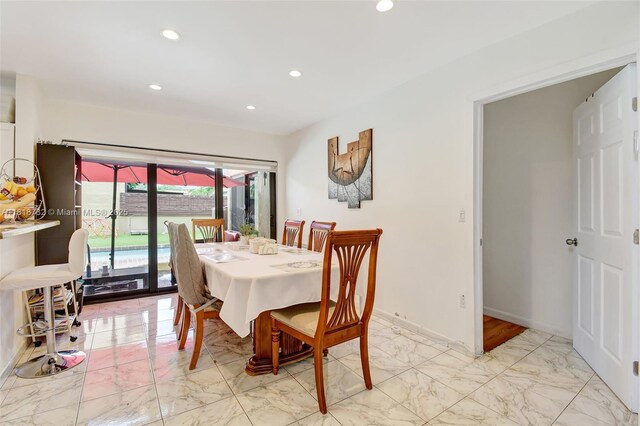 1057 NE 202nd Ln, Miami, FL 33179 - dining area featuring light marble finish flooring, recessed lighting, and baseboards