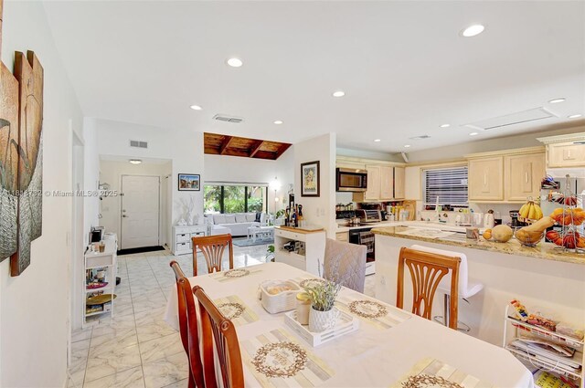 1057 NE 202nd Ln, Miami, FL 33179 - dining space with light marble finish flooring, recessed lighting, and attic access