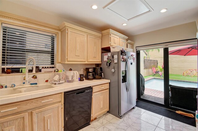 1057 NE 202nd Ln, Miami, FL 33179 - kitchen with black dishwasher, stainless steel refrigerator with ice dispenser, light brown cabinets, tile counters, and a sink