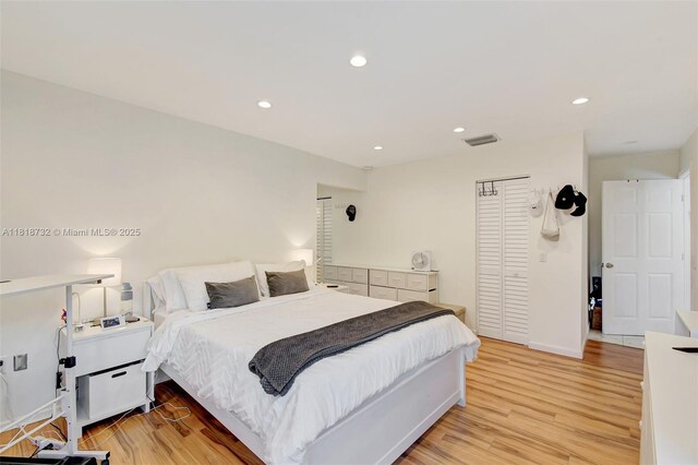 1057 NE 202nd Ln, Miami, FL 33179 - bedroom featuring light wood-style flooring, a closet, recessed lighting, and baseboards