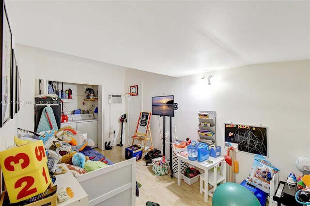 1057 NE 202nd Ln, Miami, FL 33179 - bedroom with wood finished floors, washer and dryer, and a wall mounted AC