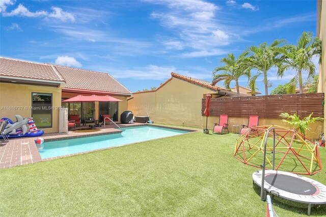 1057 NE 202nd Ln, Miami, FL 33179 - outdoor pool featuring a grill and a patio area