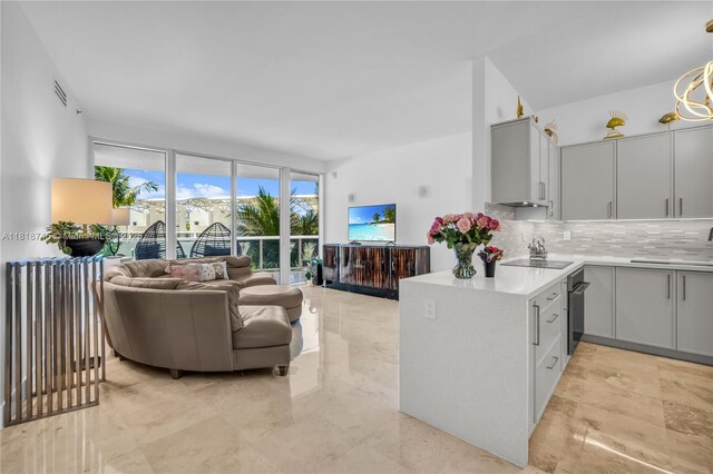 400 Alton Rd Unit 407, Miami Beach, FL 33139 - kitchen with backsplash, open floor plan, gray cabinetry, and light countertops