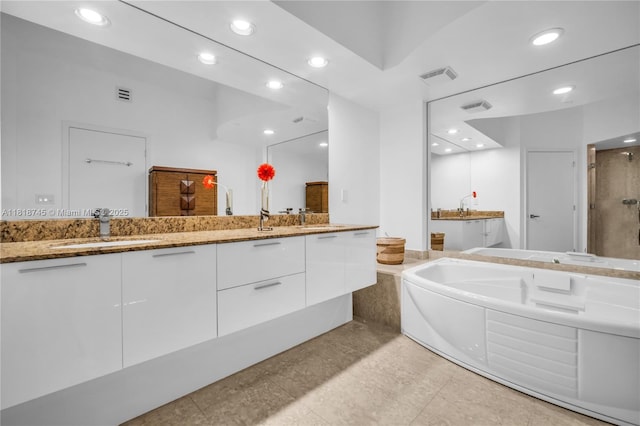 400 Alton Rd Unit 407, Miami Beach, FL 33139 - bathroom featuring double vanity, recessed lighting, a stall shower, and a garden tub