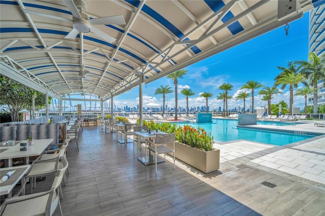 400 Alton Rd Unit 407, Miami Beach, FL 33139 - community pool with a patio, a ceiling fan, and outdoor dining area
