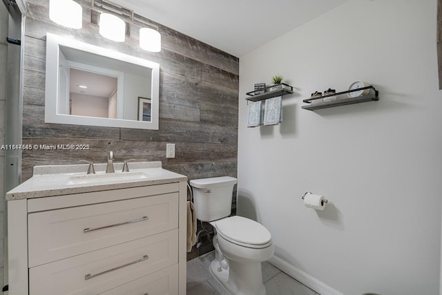 2900 NE 14th St Cswy Unit 410, Pompano Beach, FL 33062 - bathroom with wood walls, toilet, vanity, and baseboards
