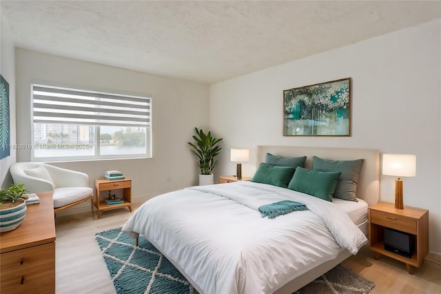 5501 NW 7th St Unit E408, Miami, FL 33126 - bedroom with light wood-style flooring and baseboards