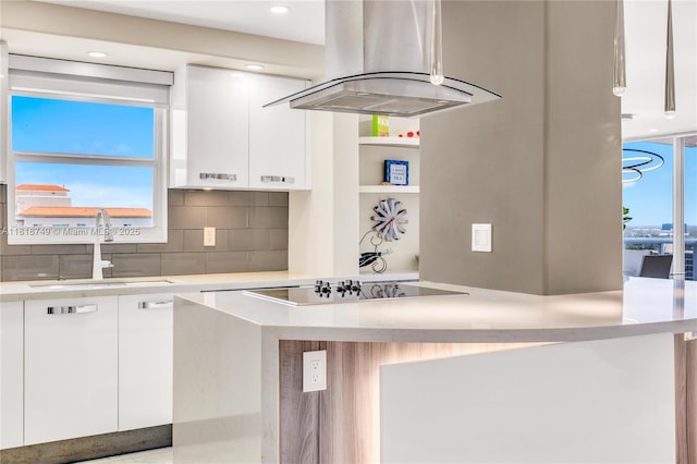 3015 N Ocean Blvd Unit 17A, Fort Lauderdale, FL 33308 - kitchen with island range hood, black electric stovetop, white cabinets, light countertops, and recessed lighting