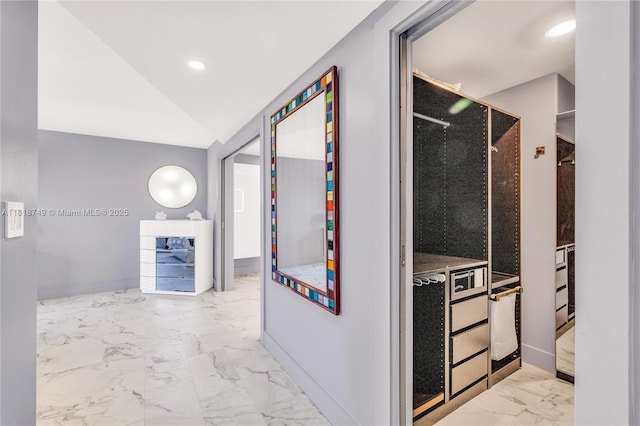 3015 N Ocean Blvd Unit 17A, Fort Lauderdale, FL 33308 - kitchen with marble look tiles, vaulted ceiling, and recessed lighting