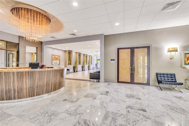 3015 N Ocean Blvd Unit 17A, Fort Lauderdale, FL 33308 - reception area with french doors, a chandelier, and recessed lighting