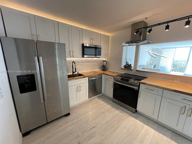 2801 NE 183rd St Unit 1611W, Aventura, FL 33160 - kitchen featuring stainless steel appliances, butcher block countertops, a sink, island exhaust hood, and light wood-type flooring