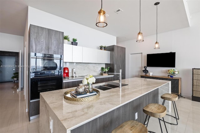 480 NE 31st St Unit Ph5303, Miami, FL 33137 - kitchen with modern cabinets, light tile patterned floors, and light stone counters