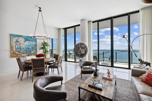 480 NE 31st St Unit Ph5303, Miami, FL 33137 - living room featuring floor to ceiling windows, a chandelier, tile patterned flooring, and a water view
