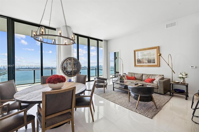480 NE 31st St Unit Ph5303, Miami, FL 33137 - dining space featuring a wall of windows, a chandelier, and a water view
