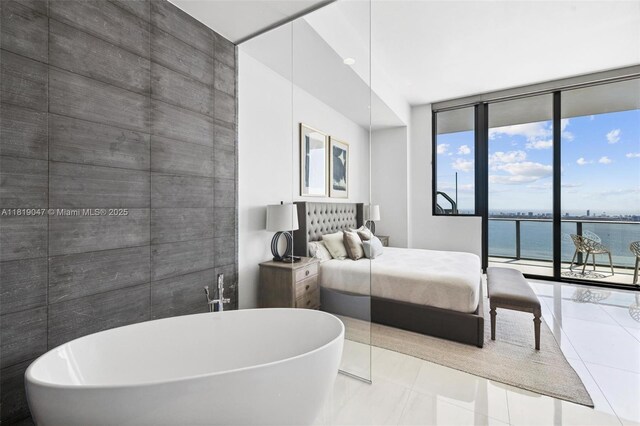 480 NE 31st St Unit Ph5303, Miami, FL 33137 - tiled bedroom featuring floor to ceiling windows, access to exterior, and a water view