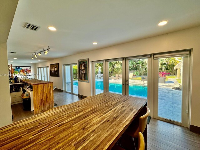 7650 SW 78th Ct, Miami, FL 33143 - dining room with french doors, wood finished floors, track lighting, and recessed lighting