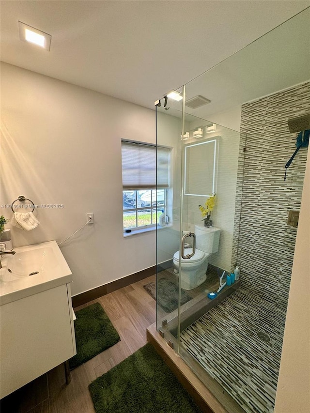 7650 SW 78th Ct, Miami, FL 33143 - bathroom with wood finished floors, vanity, and a stall shower