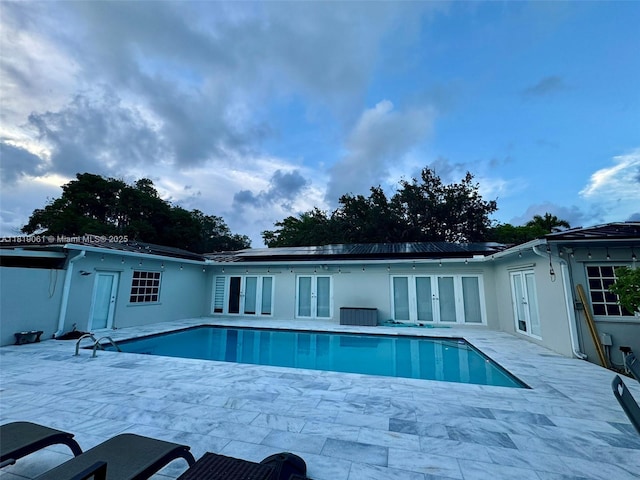 7650 SW 78th Ct, Miami, FL 33143 - back of house featuring french doors, an outdoor pool, and a patio area