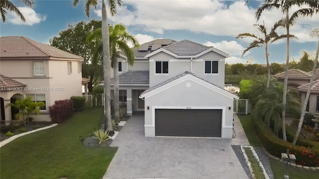1828 Aspen Ln, Weston, FL 33327 - view of front of property featuring driveway, a garage, a front yard, stucco siding, and a tile roof