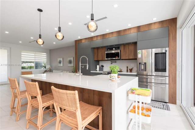 1828 Aspen Ln, Weston, FL 33327 - kitchen featuring stainless steel appliances, a sink, light countertops, modern cabinets, and recessed lighting