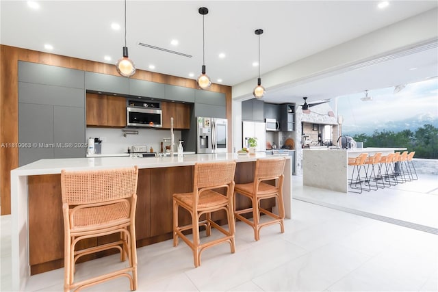 1828 Aspen Ln, Weston, FL 33327 - kitchen featuring appliances with stainless steel finishes, modern cabinets, light countertops, decorative light fixtures, and recessed lighting