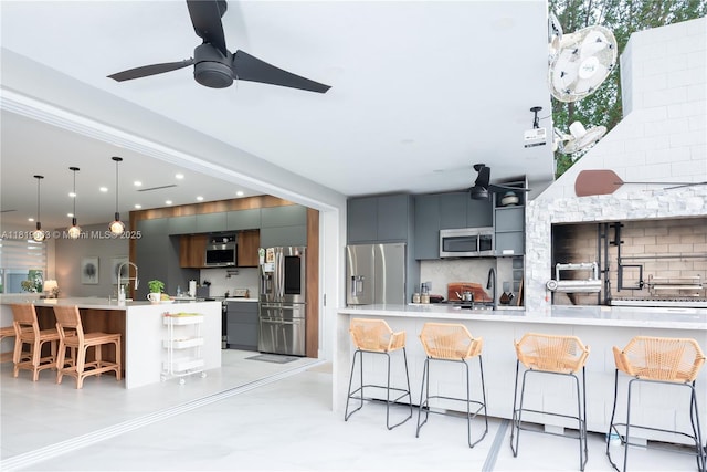 1828 Aspen Ln, Weston, FL 33327 - kitchen with modern cabinets, stainless steel appliances, a kitchen bar, tasteful backsplash, and recessed lighting