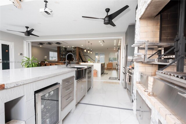 1828 Aspen Ln, Weston, FL 33327 - kitchen with wine cooler, a ceiling fan, light stone countertops, and a warming drawer