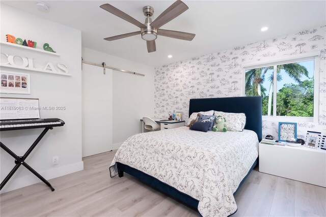 1828 Aspen Ln, Weston, FL 33327 - bedroom with a barn door, light wood finished floors, recessed lighting, and ceiling fan