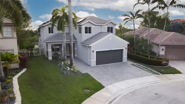 1828 Aspen Ln, Weston, FL 33327 - traditional-style house featuring decorative driveway, a tiled roof, stucco siding, and a garage