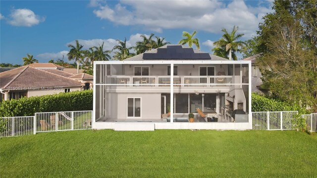 1828 Aspen Ln, Weston, FL 33327 - back of house with a sunroom, solar panels, a balcony, and a fenced backyard