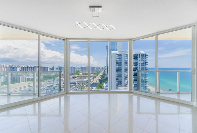 16699 Collins Ave Unit 2107, Sunny Isles Beach, FL 33160 - tiled spare room with a wall of windows, a view of city, and a water view