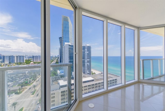 16699 Collins Ave Unit 2107, Sunny Isles Beach, FL 33160 - unfurnished sunroom with plenty of natural light, a view of city, and a water view