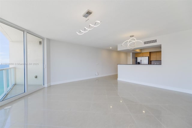 16699 Collins Ave Unit 2107, Sunny Isles Beach, FL 33160 - unfurnished living room with light tile patterned floors and baseboards