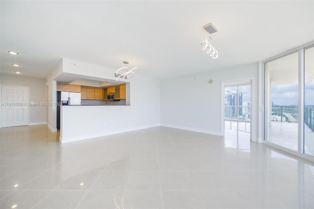 16699 Collins Ave Unit 2107, Sunny Isles Beach, FL 33160 - unfurnished living room featuring light tile patterned flooring, a wall of windows, and recessed lighting
