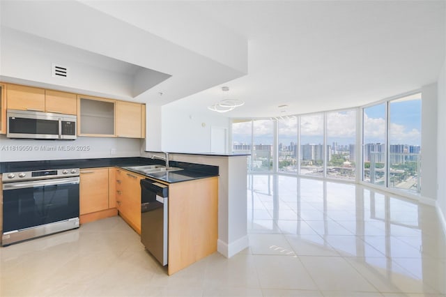 16699 Collins Ave Unit 2107, Sunny Isles Beach, FL 33160 - kitchen with appliances with stainless steel finishes, light tile patterned flooring, light brown cabinetry, dark countertops, and floor to ceiling windows