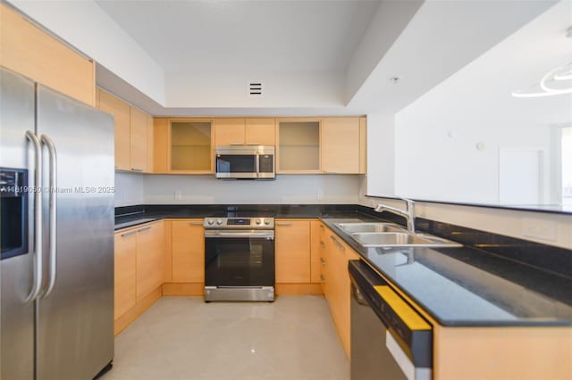16699 Collins Ave Unit 2107, Sunny Isles Beach, FL 33160 - kitchen with appliances with stainless steel finishes, light brown cabinetry, a peninsula, dark countertops, and glass insert cabinets