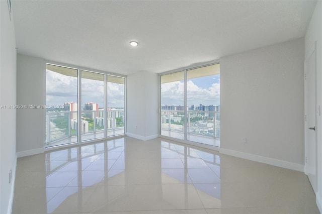 16699 Collins Ave Unit 2107, Sunny Isles Beach, FL 33160 - empty room with a view of city, expansive windows, recessed lighting, and light tile patterned floors